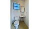 Cozy half bathroom with a toilet, a sink, and medicine cabinet at 6126 16Th St, Zephyrhills, FL 33542