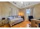 Bedroom featuring hardwood floors, textured walls, and a large window at 80 Squire Ct, Dunedin, FL 34698