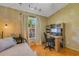 Bedroom featuring hardwood floors, textured walls, and natural light at 80 Squire Ct, Dunedin, FL 34698