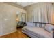 Bedroom featuring hardwood floors, textured walls, and sliding mirror doors at 80 Squire Ct, Dunedin, FL 34698