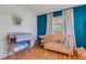 Bright Bedroom with hardwood floors, natural light, and a light wood crib at 80 Squire Ct, Dunedin, FL 34698