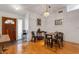Dining room featuring hardwood floors, white walls, and view of the front door at 80 Squire Ct, Dunedin, FL 34698