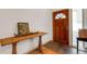 Inviting entryway featuring a wooden console table and a charming wood front door with glass at 80 Squire Ct, Dunedin, FL 34698
