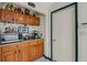 Close-up of the kitchen area featuring wooden cabinets, countertop appliances, and direct access to a doorway at 80 Squire Ct, Dunedin, FL 34698