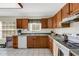 Functional kitchen with tile flooring and ample cabinets for storage, ready for culinary adventures at 80 Squire Ct, Dunedin, FL 34698