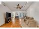 Inviting living room with hardwood floors, a ceiling fan, and a comfortable seating arrangement at 80 Squire Ct, Dunedin, FL 34698