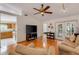 Open concept living room and kitchen featuring hardwood floors and access to a private patio at 80 Squire Ct, Dunedin, FL 34698