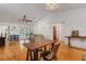 Bright living room with hardwood floors, dining area, and French doors to a private patio at 80 Squire Ct, Dunedin, FL 34698