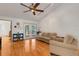 Comfortable living room featuring hardwood floors, French doors, and a cozy seating area at 80 Squire Ct, Dunedin, FL 34698
