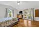 Inviting main bedroom featuring bright natural light, wood floors, and backyard access at 80 Squire Ct, Dunedin, FL 34698
