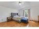 Inviting main bedroom featuring bright natural light, wood floors, and serene decor at 80 Squire Ct, Dunedin, FL 34698