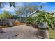 This backyard patio features a barbeque grill and a screened-in room, perfect for outdoor entertaining at 80 Squire Ct, Dunedin, FL 34698
