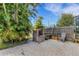 This backyard patio features a brick barbeque grill and a privacy fence, perfect for outdoor entertaining at 80 Squire Ct, Dunedin, FL 34698
