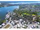 Wide aerial perspective of the community, showcasing the lake, trees, and neighborhood layout at 807 Saint Charles Dr, Tarpon Springs, FL 34689