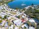 Aerial view of the community showcasing the homes, streets, and proximity to the lake at 807 Saint Charles Dr, Tarpon Springs, FL 34689