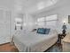 Cozy bedroom with white walls and two windows for natural light, storage, and ceiling fan at 807 Saint Charles Dr, Tarpon Springs, FL 34689