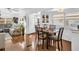 Open dining area adjacent to the living room featuring a wooden table and comfortable seating at 807 Saint Charles Dr, Tarpon Springs, FL 34689