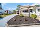 Charming single-story home showcasing well-maintained landscaping and a gray driveway at 807 Saint Charles Dr, Tarpon Springs, FL 34689