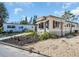 Charming single-story home with neutral siding, awnings, and tidy landscaping at 807 Saint Charles Dr, Tarpon Springs, FL 34689