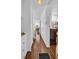 Hallway with wood floors, white trim, and glimpses into the bedroom and dining area at 807 Saint Charles Dr, Tarpon Springs, FL 34689