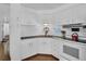 Compact kitchen featuring white appliances and plenty of cabinet space at 807 Saint Charles Dr, Tarpon Springs, FL 34689