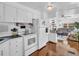 Kitchen showcases white cabinetry, essential appliances, and an open layout to the living area at 807 Saint Charles Dr, Tarpon Springs, FL 34689