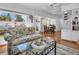 Open-concept living room with hardwood floors and views of the dining area at 807 Saint Charles Dr, Tarpon Springs, FL 34689