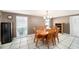 Dining room with a wooden table, seating for six, and natural light from the window at 8415 Westridge Dr, Tampa, FL 33615