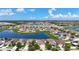 Wide aerial view of a beautiful community centered around a large pond on a bright, sunny day at 924 Peregrine Hill Pl, Ruskin, FL 33570