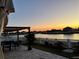 Enjoy this back patio with a beautiful water view and pergola, perfect for outdoor dining at 924 Peregrine Hill Pl, Ruskin, FL 33570