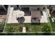 Aerial view of a backyard with brick patio, lawn, white fence, garden, and patio furniture with umbrella and a pergola at 924 Peregrine Hill Pl, Ruskin, FL 33570