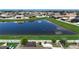 Lush backyard view overlooking the serene lake with a white fence creating a peaceful outdoor retreat at 924 Peregrine Hill Pl, Ruskin, FL 33570