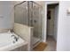 Bright bathroom with soaking tub and separate glass-enclosed shower at 924 Peregrine Hill Pl, Ruskin, FL 33570