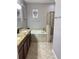 Relaxing bathroom with double sinks, granite counters, soaking tub, and a glass-enclosed shower at 924 Peregrine Hill Pl, Ruskin, FL 33570