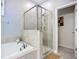 This bathroom showcases a soaking tub and a separate glass-enclosed shower with tile surround at 924 Peregrine Hill Pl, Ruskin, FL 33570