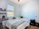 Bright bedroom featuring a twin bed, shelf, and window with plenty of natural light at 924 Peregrine Hill Pl, Ruskin, FL 33570