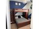 Shared bedroom featuring a bunk bed with stairs and drawers for ample storage at 924 Peregrine Hill Pl, Ruskin, FL 33570
