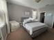 Bright bedroom with neutral paint, plush carpet, and natural light from the window at 924 Peregrine Hill Pl, Ruskin, FL 33570