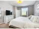 Calm bedroom with a white dresser, neutral decor, and plenty of natural light at 924 Peregrine Hill Pl, Ruskin, FL 33570