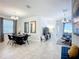 Open-concept dining area featuring modern chandelier, and ample natural light, seamlessly flowing into the living space at 924 Peregrine Hill Pl, Ruskin, FL 33570