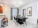 Contemporary dining room with a chandelier, stylish decor, and a set of mirrors enhancing the space at 924 Peregrine Hill Pl, Ruskin, FL 33570