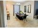Elegant dining room featuring a large wooden table, modern chandelier and decorative mirrors at 924 Peregrine Hill Pl, Ruskin, FL 33570