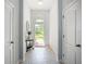Bright entryway with neutral tile flooring, a decorative table, and an arched window above the front door at 924 Peregrine Hill Pl, Ruskin, FL 33570