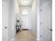 Bright foyer with a white door, tile floor, and decorative table at 924 Peregrine Hill Pl, Ruskin, FL 33570