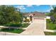 Inviting home with lush landscaping, a well-maintained lawn, and a spacious driveway leading to a two-car garage at 924 Peregrine Hill Pl, Ruskin, FL 33570