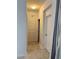 Bright hallway with neutral tile flooring and decorative molding at 924 Peregrine Hill Pl, Ruskin, FL 33570