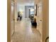 Inviting hallway with neutral tile flooring leading to a bright living space with ample natural light at 924 Peregrine Hill Pl, Ruskin, FL 33570