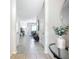 Inviting hallway featuring neutral tones, tile flooring, and a decorative table at 924 Peregrine Hill Pl, Ruskin, FL 33570