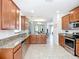Modern kitchen with stainless steel appliances, granite counters, kitchen island and tile flooring at 924 Peregrine Hill Pl, Ruskin, FL 33570