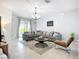 Beautiful living room with a large sectional sofa, tile flooring, and sliding glass doors to the patio at 924 Peregrine Hill Pl, Ruskin, FL 33570
